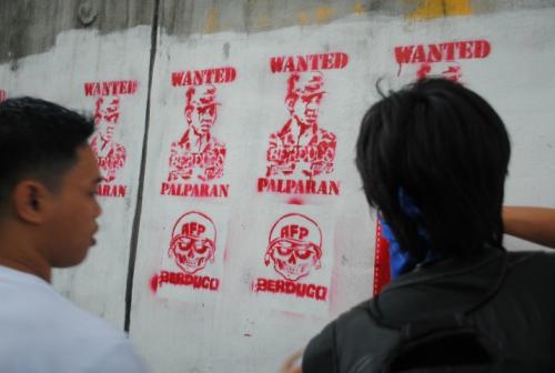 Image of Palparan in stencil being painted by members of rights organizations
